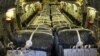 A U.S. Defense Department photo shows pallets of bottled water are loaded aboard a U.S. Air Force C-17 Globemaster III aircraft in preparation for a humanitarian airdrop over Iraq Aug. 8, 2014.