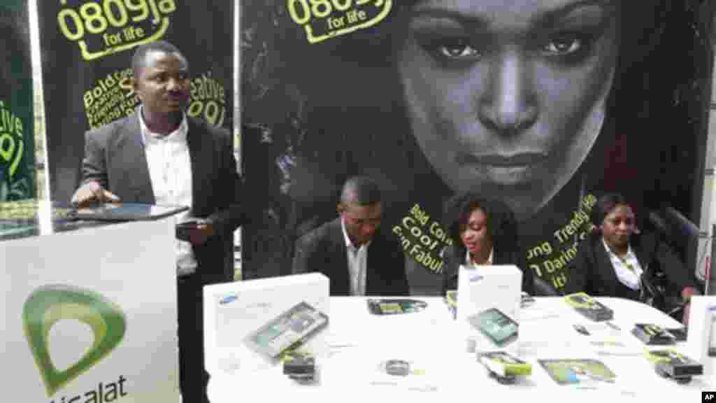 Staffs of Etisalat Nigeria, wait for customers during the launch of mobile number portability, in Lagos, Nigeria, Monday, April 22, 2013.
