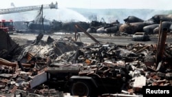 Remains of a home lie in rubble as firefighters continue working at scene of a train derailment, Lac Megantic, Quebec, July 7, 2013.