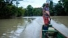 Bernardino Mosquera, a river guardian, maneuvers on water near Paimado, Colombia, Sept. 23, 2024.