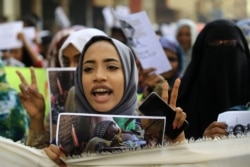 FILE - Sudanese from various women's groups take part in a march through the streets of the capital Khartoum to call for the best outcome for women in the period of political transition, May 30, 2019.