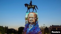 The image of late Rep. John Lewis, a pioneer of the civil rights movement and long-time member of the U.S. House of Representatives, is projected on the statue of Confederate General Robert E. Lee in Richmond, Virginia, July 19, 2020.