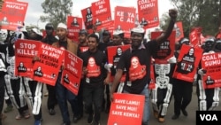 Protestors carrying placards march in the streets of Nairobi, Kenya, June 5, 2018, demanding the government halt a project to build a coal power plant in the city of Lamu. (M. Yusuf/VOA)