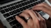 (FILE) In this June 19, 2017, file photo, a person types on a laptop keyboard in North Andover, Mass.