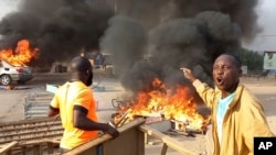 FILE —Anti-government demonstrators set a barricade on fire during clashes in N'Djamena, Chad, October 20, 2022.
