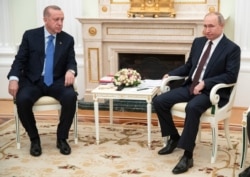 Russian President Vladimir Putin, right, and Turkish President Recep Tayyip Erdogan are seen during their meeting in the Kremlin, in Moscow, Russia, March 5, 2020.
