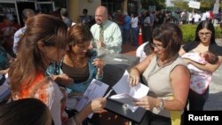 Electores hacen fila para votar el día de los comicios en la ciudad de Doral, en el oeste de Miami.