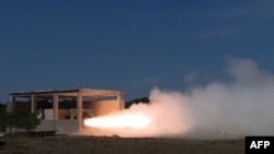 FILE —This undated picture released by North Korea's official Korean Central News Agency on November 15, 2023 shows the first ground combustion test of a high-power solid fuel engine for a new intermediate-range ballistic missile, at an undisclosed locatation in North Korea.