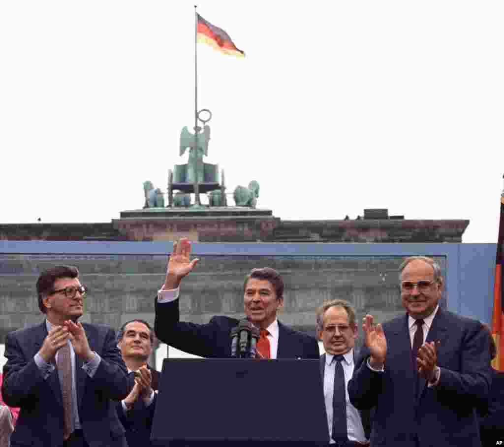 **ADVANCE FOR TUESDAY, JAN. 26** FILE- In this June 12, 1987 file photo U.S. President Reagan acknowledges the crowd after his speech in front of the Brandenburg Gate in West Berlin, where he said &quot;Mr. Gorbachev, tear down this wall!&quot;