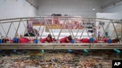 Staff workers clean a tapestry at the Royal Tapestry Factory in Madrid, Spain, Friday, Nov. 30, 2023. (AP Photo/Manu Fernandez)