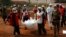 Local Red Cross workers move bodies from a mass grave at a military camp in the 200 villas neighborhood of Bangui, Feb. 17, 2014.