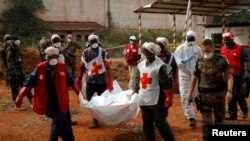 Les éléments de la Croix rouge transportent un cadavre après de Bangui, Centrafrique, 17 février 2014.