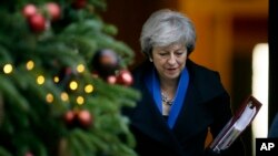 Britain's Prime Minister Theresa May leaves 10 Downing Street for Prime Minister's Questions at the House of Commons, in London, Dec. 19, 2018. 