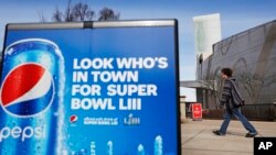 A Pepsi advertisement stands outside the World of Coca-Cola museum in Atlanta, Jan. 30, 2019. The Patriots and the Rams aren't the only ones battling for Super Bowl supremacy this week. Pepsi and Coke also seem to be squaring off. Pepsi, an official NFL s