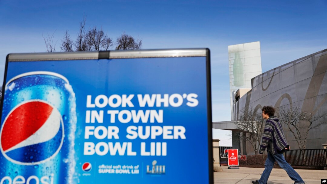 A Pepsi advertisement stands outside the World of Coca-Cola museum in Atlanta, Jan. 30, 2019. The Patriots and the Rams aren't the only ones battling for Super Bowl supremacy this week. Pepsi and Coke also seem to be squaring off. Pepsi, an official NFL s
