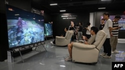 A young man plays Chinese action role-playing game "Black Myth: Wukong," developed by Chinese video game company Game Science, during its launch day in Shanghai on Aug. 20, 2024.