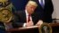 US President Donald Trump signs an executive order to impose tighter vetting of travelers entering the United States, at the Pentagon in Washington, Jan. 27, 2017. 