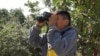 Frank Az, 9, a student at Esperanza Elementary School in Los Angeles, scans an area for bird species. (M. O'Sullivan/VOA)