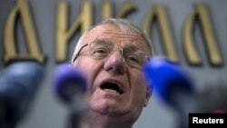 FILE - Serbian nationalist leader Vojislav Seselj speaks during a news conference inside his Serbian Radical Party headquarters in Belgrade, April 2, 2015.