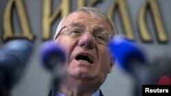 Serbian nationalist leader Vojislav Seselj speaks during a news conference inside his Serbian Radical Party headquarters in Belgrade, April 2, 2015. The Serbian ultra-nationalist, freed on compassionate grounds by a United Nations war crimes court, then ordered to return for violating the terms of his release, thumbed his nose at the court on Wednesday by setting fire to a Croatian flag.