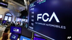FILE - The Fiat Chrysler Automobiles logo appears above a post on the floor of the New York Stock Exchange, May 28, 2019. 