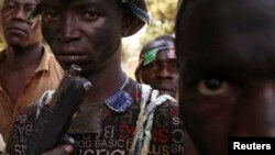 Anti-Balaka fighters pose at their base in the Boeing district of the Central African Republic's capital Bangui, Jan. 6, 2014.