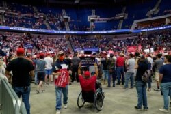 President Donald Trump supporters listen to Trump speak during a campaign rally at the BOK Center, June 20, 2020, in Tulsa, Okla.