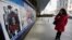 A woman looks at a poster of the film "Django Unchained" outside a cinema in Beijing, April 11, 2013.
