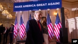 Former President Donald Trump and former first lady Melania Trump arrive to announce that Trump is running for president for the third time at Mar-a-Lago in Palm Beach, Florida, Nov. 15, 2022. 