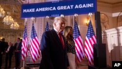 Former President Donald Trump and former first lady Melania Trump arrive to announce that Trump is running for president for the third time at Mar-a-Lago in Palm Beach, Fla., Tuesday, Nov. 15, 2022. 