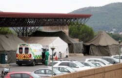 FILE - An ambulance is parked near tents erected at the parking lot of the Steve Biko Academic Hospital, amid a nationwide coronavirus disease (COVID-19) lockdown, in Pretoria, South Africa, Jan. 11, 2021.