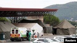 FILE - An ambulance is parked near tents erected at the parking lot of the Steve Biko Academic Hospital, amid a nationwide coronavirus disease (COVID-19) lockdown, in Pretoria, South Africa, Jan. 11, 2021. 