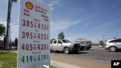 FILE - Gas prices are shown at a Shell station in Sacramento, Calif., April 23, 2019. Four major automakers said July 25 that they have reached an agreement with California on fuel efficiency rules.