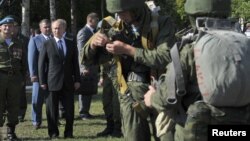 Russian President Vladimir Putin (2nd L, 1st row) visits the base of the independent airborne assault brigade number 31, on the eve of the Paratroopers' Day, in the city of Ulyanovsk, Russia, August 1, 2012.