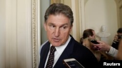 FILE - U.S. Senator Joe Manchin (D-WV) talks to reporters on Capitol Hill in Washington, U.S., Jan. 19, 2018. 