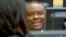 FILE - Former Congo vice president Jean-Pierre Bemba smiles while waiting for the start of his trial, at the International Criminal Court in The Hague, Netherlands, Nov. 27, 2013.