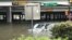 Floodwaters threaten to swallow a vehicle stranded on Interstate 45-North Freeway in Houston, Texas, Aug. 27, 2017. (C. Mendoza/VOA). 