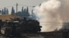 An Israeli soldier sits on top of a tank at a camp near the Israel-Gaza border, in Israel, Jan. 12, 2025. 