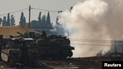 An Israeli soldier sits on top of a tank at a camp near the Israel-Gaza border, in Israel, Jan. 12, 2025. 