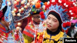 Children wearing costumes wait to perform during an event to celebrate the Chinese Lunar New Year, in Nanjing, Jiangsu province, China February 2, 2019. 