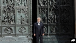 FILE - In this April 12, 2020 photo, Italian singer Andrea Bocelli, who had COVID-19, performs outside the Duomo cathedral, in Milan, Italy. He says the pandemic lockdown in his country made him feel ‘humiliated and offended’ for depriving him of freedom.