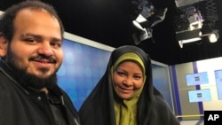 In this undated photo provided by Iranian state television's English-language service, Press TV, American-born news anchor Marzieh Hashemi, right, smiles as she stands with her son, Hussein Hashemi, in Tehran, Iran. 