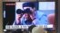FILE - In this Aug. 2, 2019, file photo, people watch a TV showing a file footage of North Korean leader Kim Jong Un during a news program at the Seoul Railway Station in Seoul, South Korea.