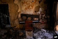 FILE - Destroyed furniture and charred walls are seen in a home that came under attack during a massive Hamas invasion into Kibbutz Nir Oz, Israel, Oct. 19, 2023.