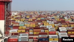 FILE - Containers sit at a terminal at the Yangshan deepwater port, in Shanghai, China, Oct. 10, 2024.