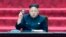 FILE - In this April 9, 2014, image made from video, North Korean leader Kim Jong Un holds up parliament membership certificate during the Supreme People's Assembly in Pyongyang, North Korea.