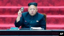 FILE - North Korean leader Kim Jong Un holds up parliament membership certificate during the Supreme People's Assembly in Pyongyang, North Korea.