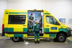 Paramedics clean and disinfect an ambulance after dropping a patient at the Intensive Care Unit at Danderyd Hospital near Stockholm on May 13, 2020, during the coronavirus COVID-19 pandemic.