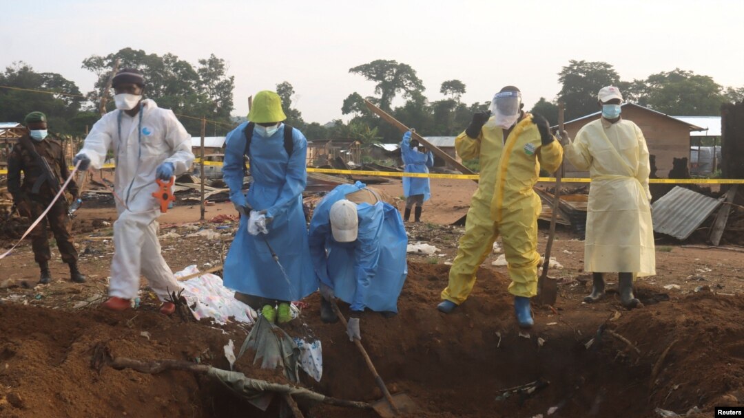 Volunteers and Congolese security officers dig in search for bodies of residents killed in an attack by suspected Islamist rebels at Masala, Democratic Republic of Congo, June 9, 2024. Authorities say the rebels struck again on June 13, killing at least 42 people.