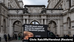 FILE - A digital advertising van, commissioned by Ukrainian campaigners, passes by the Foreign, Commonwealth & Development Office, with a message to urge Britain to stand firm against Russia's attack on Ukraine, in London, Nov. 18, 2024. 